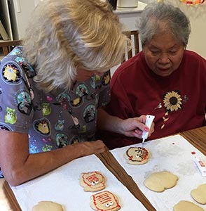 resident helps with baking cookies